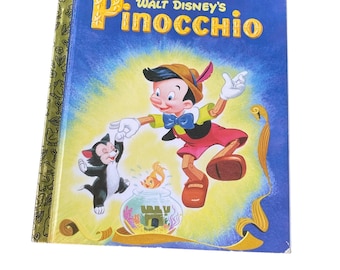 May include: A vintage Little Golden Book titled "Walt Disney's Pinocchio." The cover features Pinocchio, a black cat, and a goldfish in a bowl against a blue background. The book's spine is gold with green and white floral designs.