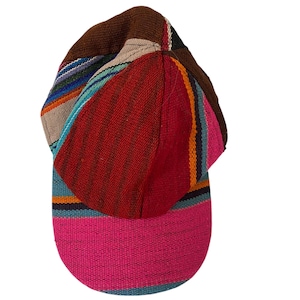 May include: A colorful baseball cap with a woven fabric design. The cap features a brown top, a red center, and a pink brim. The design includes stripes of blue, orange, and other colors.