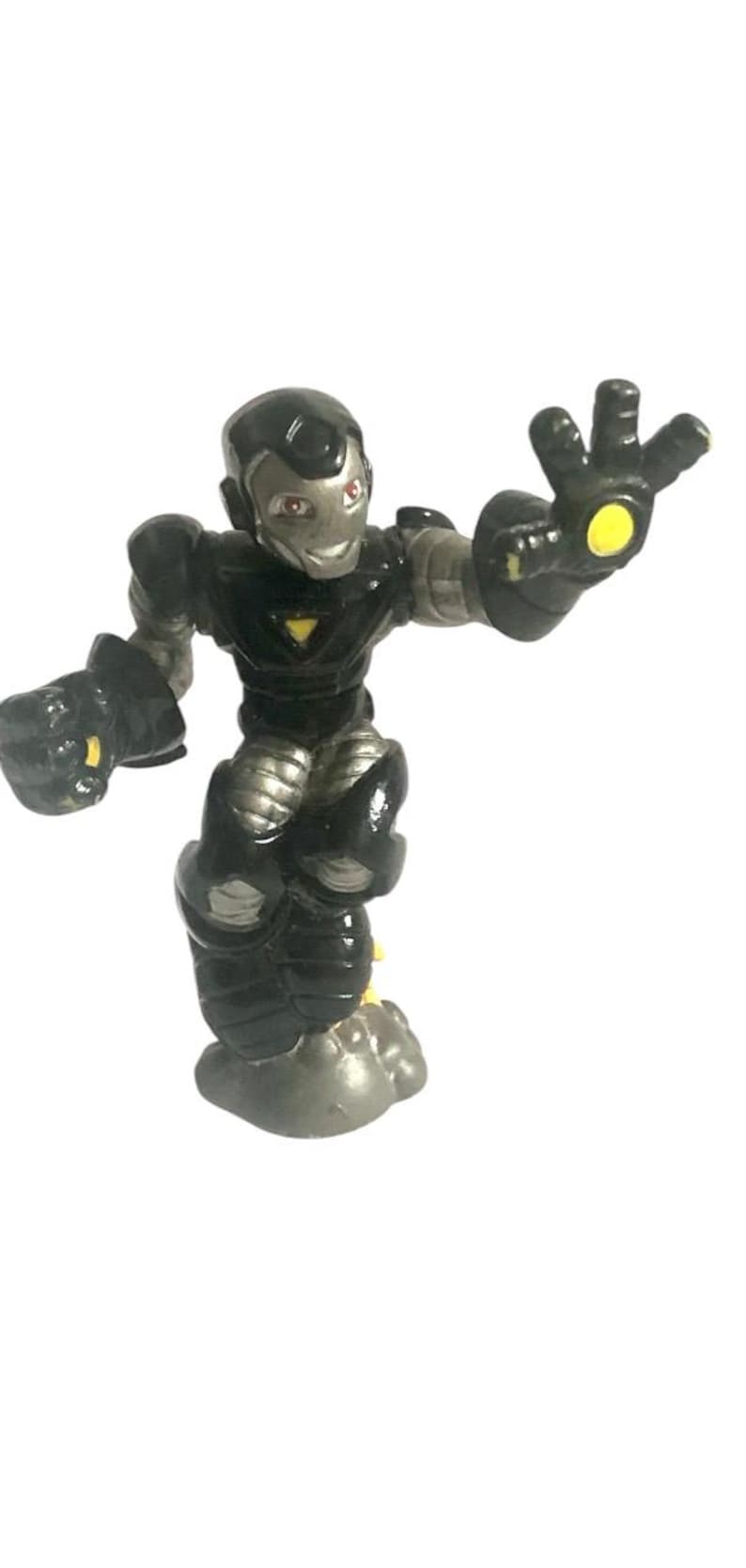 May include: Black and silver action figure of a superhero with a yellow glowing hand. The figure is standing on a gray base.