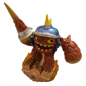 May include: A red and brown action figure of a character with a blue helmet, yellow spikes, and a large yellow spear. The figure is on a gold base with flames.