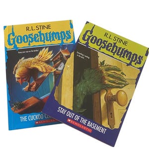 May include: Two vintage Goosebumps books by R.L. Stine. One book cover features a cuckoo bird, the other a green hand reaching for a doorknob. The titles are "The Cuckoo Clock of Doom" and "Stay Out of the Basement".