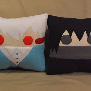 May include: Two plush pillows, one white with red eyes and a blue shirt, the other black with grey eyes and a grey mouth.