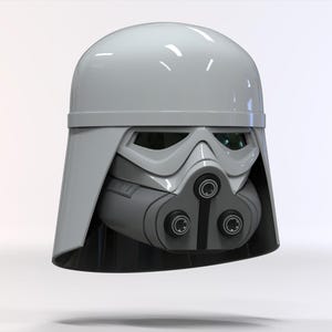 May include: A grey and white helmet with a distinctive design, featuring a rounded top, angular visor, and a detailed lower section with circular elements. The helmet has a glossy finish and a futuristic aesthetic.