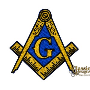 May include: Embroidered patch featuring the Masonic Square and Compasses symbol. The design includes a blue triangle with a yellow 'G' in the center, surrounded by yellow square and compasses. The patch has a detailed, stitched appearance, with the text "Classic Designs" at the bottom.