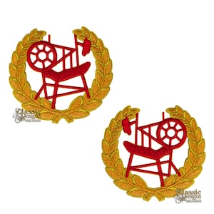 May include: Two red spinning wheel designs, each encircled by a gold laurel wreath. The designs are embroidered with a classic look. The text "classic designs" is visible in the lower left corner of the image.