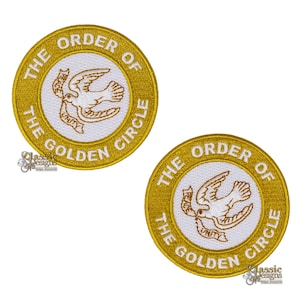 May include: Two circular embroidered patches with a gold border and white centre. Each patch features a dove carrying a banner with the word "Unity". The text "The Order of the Golden Circle" is embroidered around the edge.