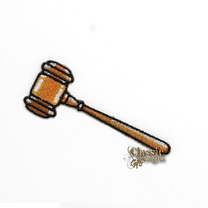 May include: A gold-colored gavel with a black handle. The gavel is a symbol of authority and justice.