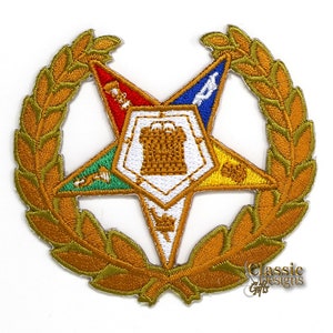 May include: Gold embroidered patch with a five-pointed star, a wreath, and a Masonic symbol in the center. The star is divided into five sections, each with a different color: red, blue, green, yellow, and white.