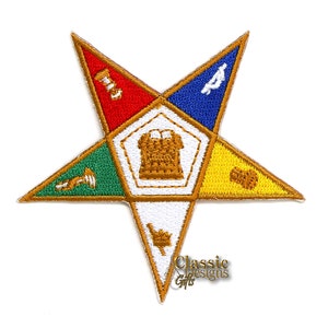 May include: A five-pointed star patch with a gold outline and different colored sections. The center of the star features a gold building with a white roof and a gold letter 'A' in the blue section.