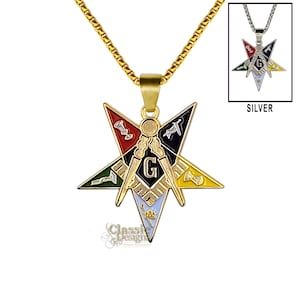 May include: Gold chain necklace with a five-pointed star pendant featuring Masonic symbols in black, red, green, yellow, and white enamel. The pendant has a 'G' in the center and the text 'SILVER' is visible in the background.