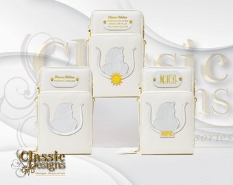 May include: White leather crossbody bags with gold zippers and accents. Each bag features a unique design with a sun emblem and text. The bags are from "Ottawa Children" and "Classic Designs."