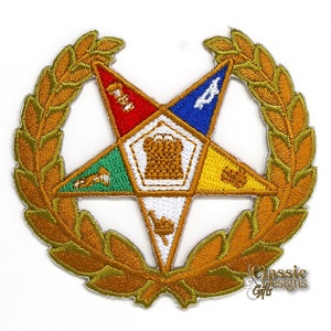 May include: Gold embroidered patch with a five-pointed star, a wreath, and symbols in the center. The star is divided into five sections, each with a different color and symbol. The colors are red, blue, green, yellow, and white. The symbols are a trowel, a plumb bob, a level, a compass, and a book.