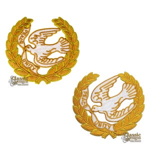 May include: Two embroidered patches with a white dove holding an olive branch, surrounded by a gold laurel wreath. The words "PEACE" and "UNITY" are embroidered on the wreath. The patches have a classic design.