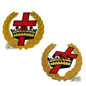May include: Two embroidered patches featuring a red cross with a crown, set within a gold laurel wreath. The crown is gold with black accents. The patches are on a white background.