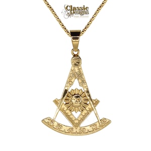May include: Gold-tone pendant necklace featuring a Masonic symbol with a compass and square, a sun with a face, and a protractor with markings. The pendant is attached to a gold-tone chain.