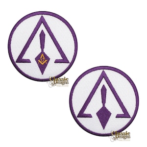 May include: Two purple and white embroidered patches with a Masonic symbol. The symbol is a purple triangle with a purple trowel inside. The patches are circular with a white background and a purple border.