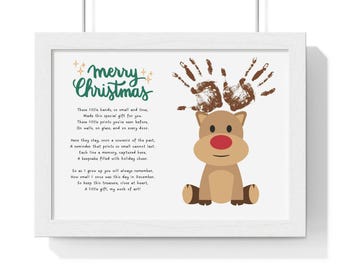 May include: A framed print with a Christmas-themed poem about a child's handprints. The poem reads "These little hands, so small and true, Made this special gift for you. These little prints you've seen before, On walls, on glass, and on every door." The print features a cartoon reindeer with a red nose and brown handprints on its antlers.