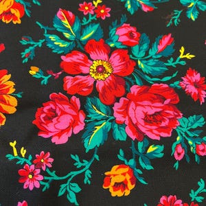 May include: Black fabric with a floral pattern featuring pink, red, orange, and yellow flowers with green leaves.