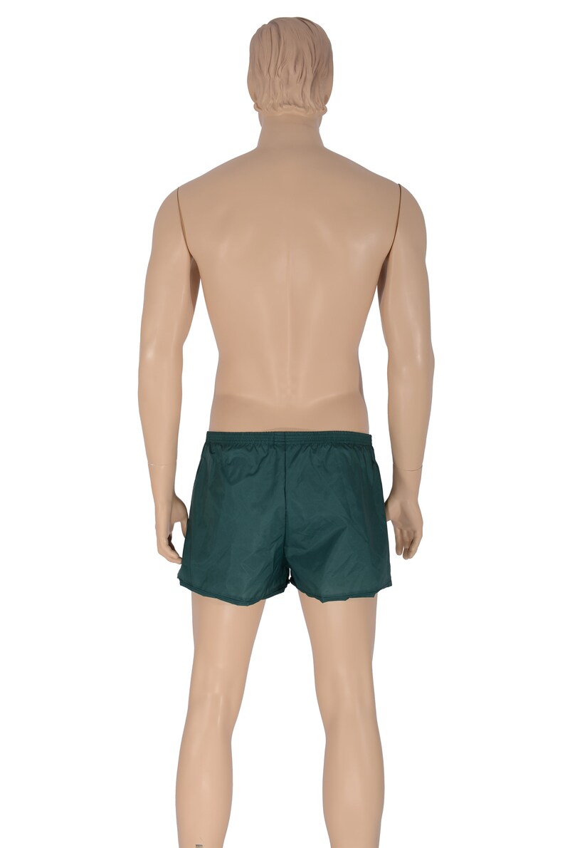 May include: A pair of dark green athletic shorts with an elastic waistband.