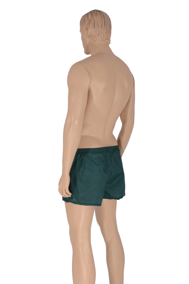 May include: A pair of dark green athletic shorts with a drawstring waist.
