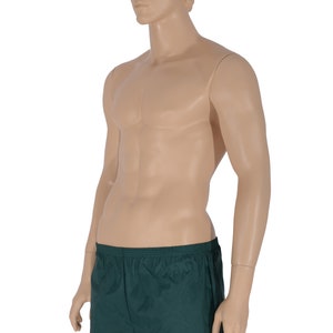 May include: A pair of dark green athletic shorts with an elastic waistband.
