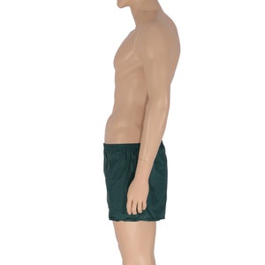 May include: A dark green pair of athletic shorts.