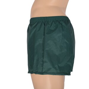 May include: Dark green athletic shorts with an elastic waistband.