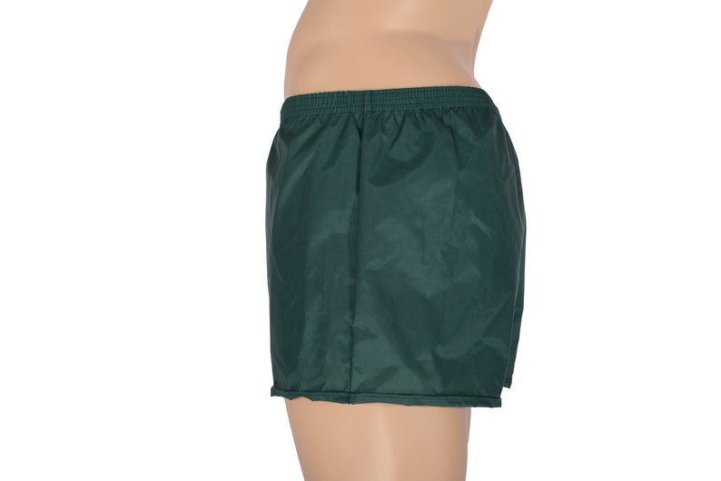 May include: Dark green athletic shorts with an elastic waistband.