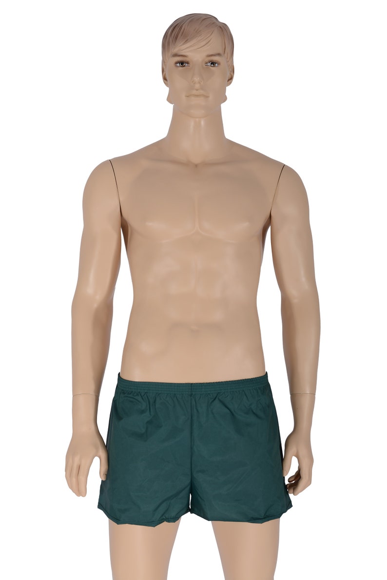 May include: A pair of dark green athletic shorts with an elastic waistband.