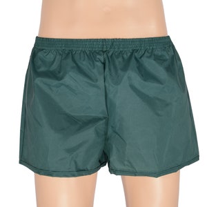 May include: A pair of dark green athletic shorts with an elastic waistband.