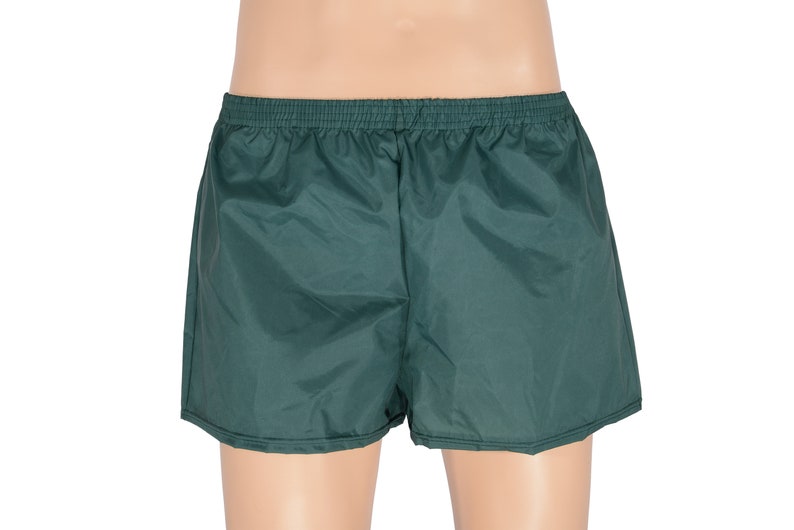 May include: A pair of dark green athletic shorts with an elastic waistband.