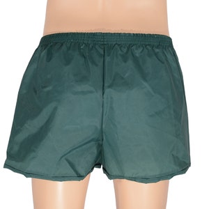May include: Dark green athletic shorts with an elastic waistband.