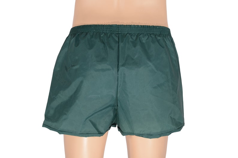 May include: Dark green athletic shorts with an elastic waistband.