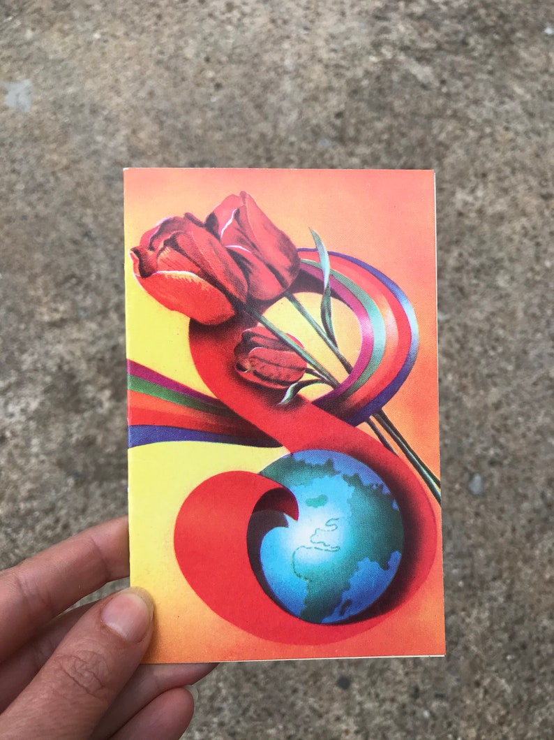 May include: A vintage postcard with a colorful design featuring a globe, tulips, and a rainbow. The globe is blue with green continents and is surrounded by a red, orange, and yellow swirl. The tulips are red and are positioned above the globe.
