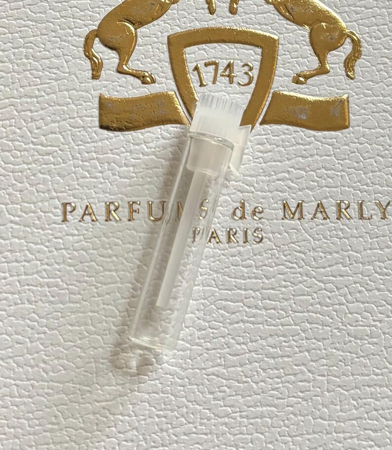 May include: A set of three ceramic mugs with a speckled, cream-colored glaze. Each mug features a different hand-painted floral design in shades of blue, green, and yellow. The mugs have a simple, rounded shape.