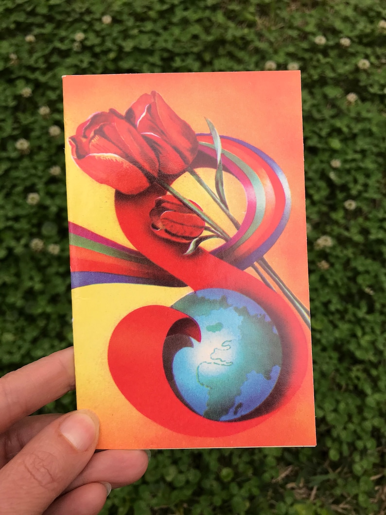 May include: A vintage postcard with a red, orange, and yellow background. A bouquet of red tulips is wrapped in a rainbow ribbon. A blue globe is in the lower right corner.