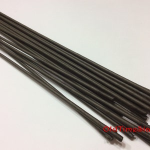 Puede incluir: Un paquete de 18 tallos de alambre metálico marrón, de aproximadamente 30 cm de largo. Los tallos están agrupados y tienen una textura ligeramente rugosa.