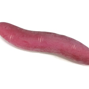 May include: A long, curved, bright pink sweet potato with a smooth surface and faint lines.