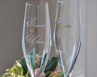 Set of personalized wedding champagne flutes decorated with gold infinity symbol