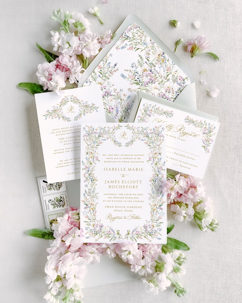 May include: A wedding invitation with a floral border and gold lettering. The invitation reads "Mr. and Mrs. Nicholas Dupont invite you to celebrate the marriage of their daughter Isabelle Marie to James Elliott Rochefort Saturday, the sixth of June two thousand twenty-four at six o'clock in the evening Swan House Gardens Atlanta, Georgia Reception to Follow"