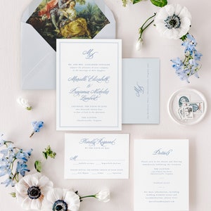 May include: A wedding invitation suite with a blue and white color scheme. The invitation features a classic font and a floral design. The RSVP card includes a choice of dinner options. The details card includes the date, time, and location of the wedding.