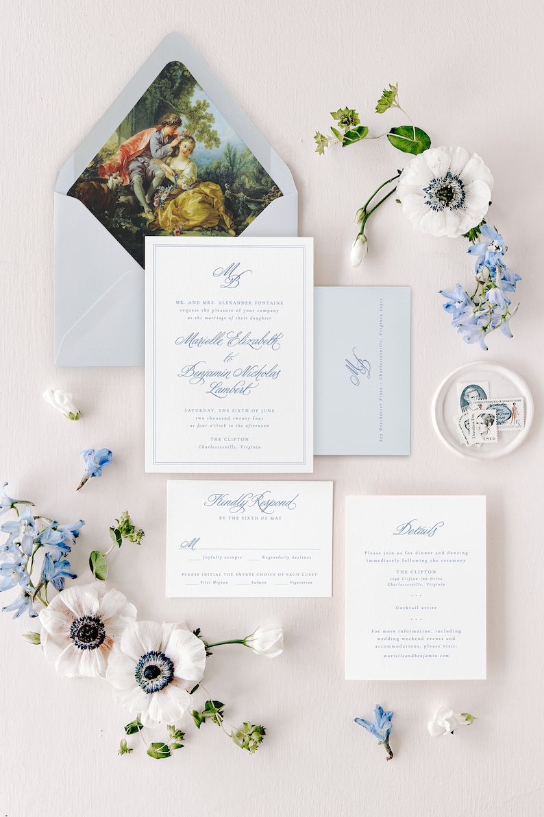 May include: A wedding invitation suite with a blue and white color scheme. The invitation features a classic font and a floral design. The RSVP card includes a choice of dinner options. The details card includes the date, time, and location of the wedding.