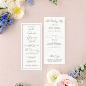 a wedding invitation card with elegant text, surrounded by a variety of colorful flowers, including white, blue, and pink flowers, as well as greenery.