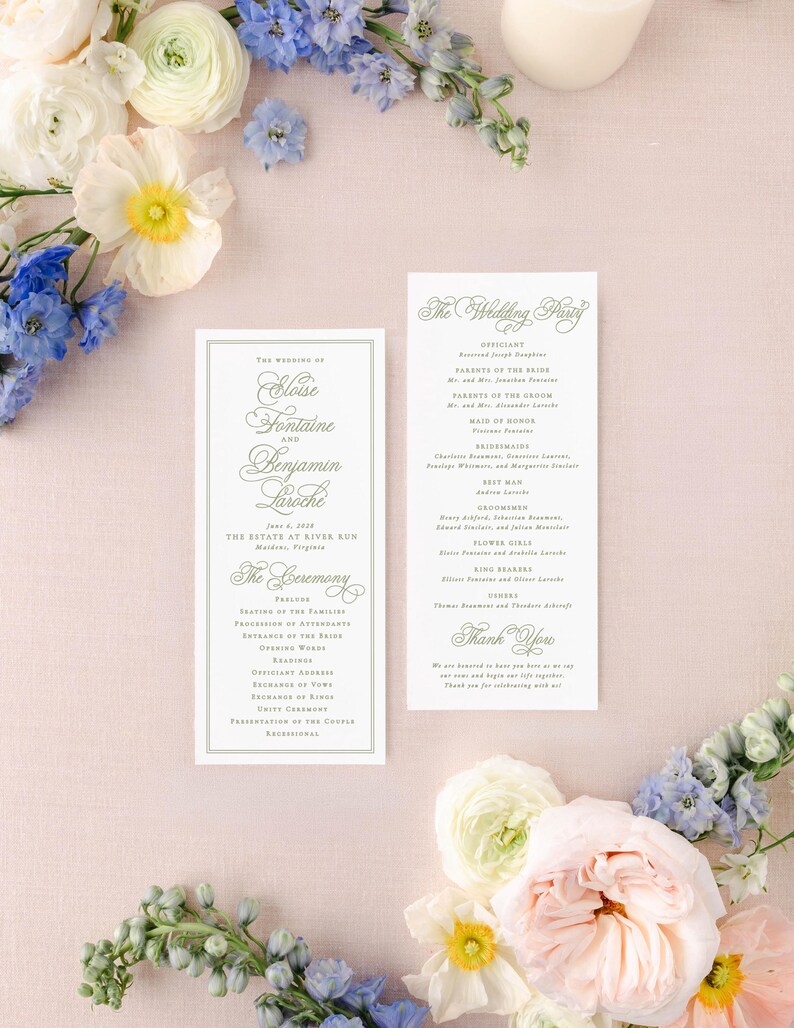 a wedding invitation card with elegant text, surrounded by a variety of colorful flowers, including white, blue, and pink flowers, as well as greenery.