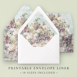May include: Printable envelope liner with a floral design in shades of pink, purple, and white. The liner is shown folded in half, with the floral design visible on the inside and outside. The text "Printable Envelope Liner" and "10 Sizes Included" is printed below the image.