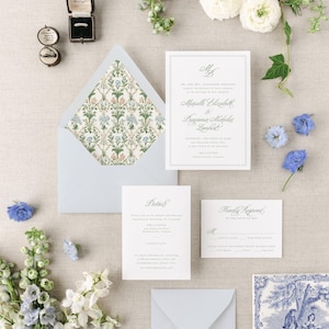 May include: Wedding invitation suite with a blue and white floral design. The invitation features the names "Mardelle Elizabeth" and "Benjamin Nicholas Lambert" and the date "Saturday, the Sixth of June, Two Thousand Twenty-Three". The invitation is on a white background with a blue border. The RSVP card is on a white background with a blue border. The details card is on a white background with a blue border.