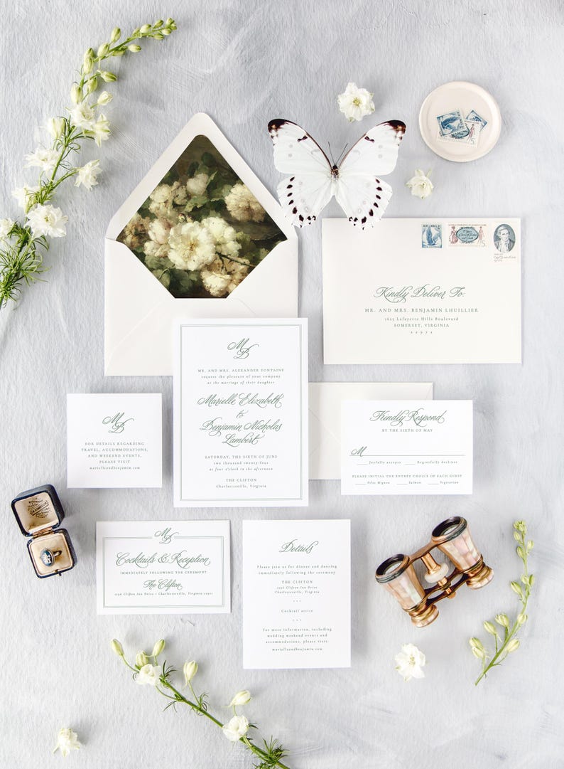 May include: Wedding invitation suite with white envelopes, a floral design on the inner envelope flap, and a white butterfly. The invitation cards are white with gray borders and green calligraphy text. The text on the invitation card reads "Mr. and Mrs. Alexander Downsborough request the honor of your presence at the marriage of their daughter Marielle Elizabeth to Benjamin Nicholas Lambert Saturday, the 15th of June, two thousand twenty-three at five o'clock in the afternoon The Clifton Charlottesville, Virginia Reception to follow at the same location.  RSVP by the first of May.  Kindly Deliver To: Mr. and Mrs. Benjamin Lucille 1600 Jefferson Hill Road Somerset, Virginia 24378"