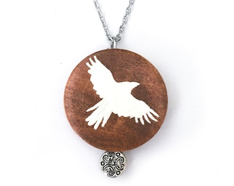 White raven painted wood pendant necklace