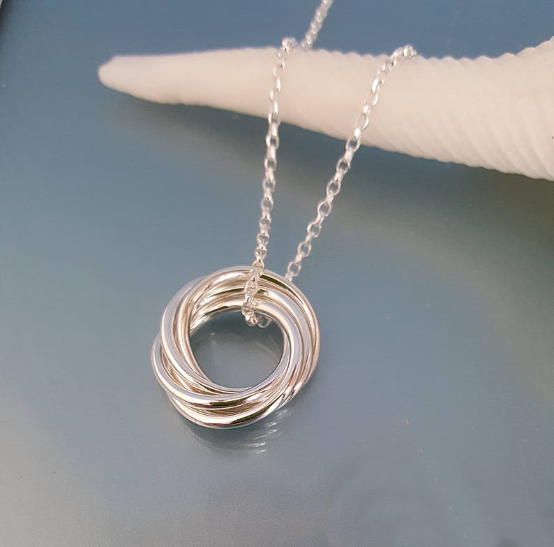 Handmade 5 ring Russian ring necklace. Five lightweight loosely interlocked solid sterling silver circles threaded on a silver chain.  Each ring is hand soldered and polished to a beautiful smooth finish. Comes on a lightweight sterling silver chain.