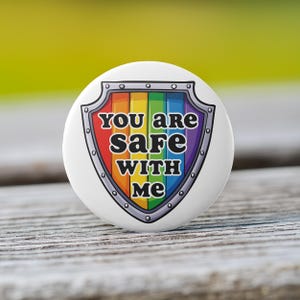 You Are Safe With Me Rainbow Shield Button in White - Available as Pin, Keychain, Magnet, or Zipper Pull